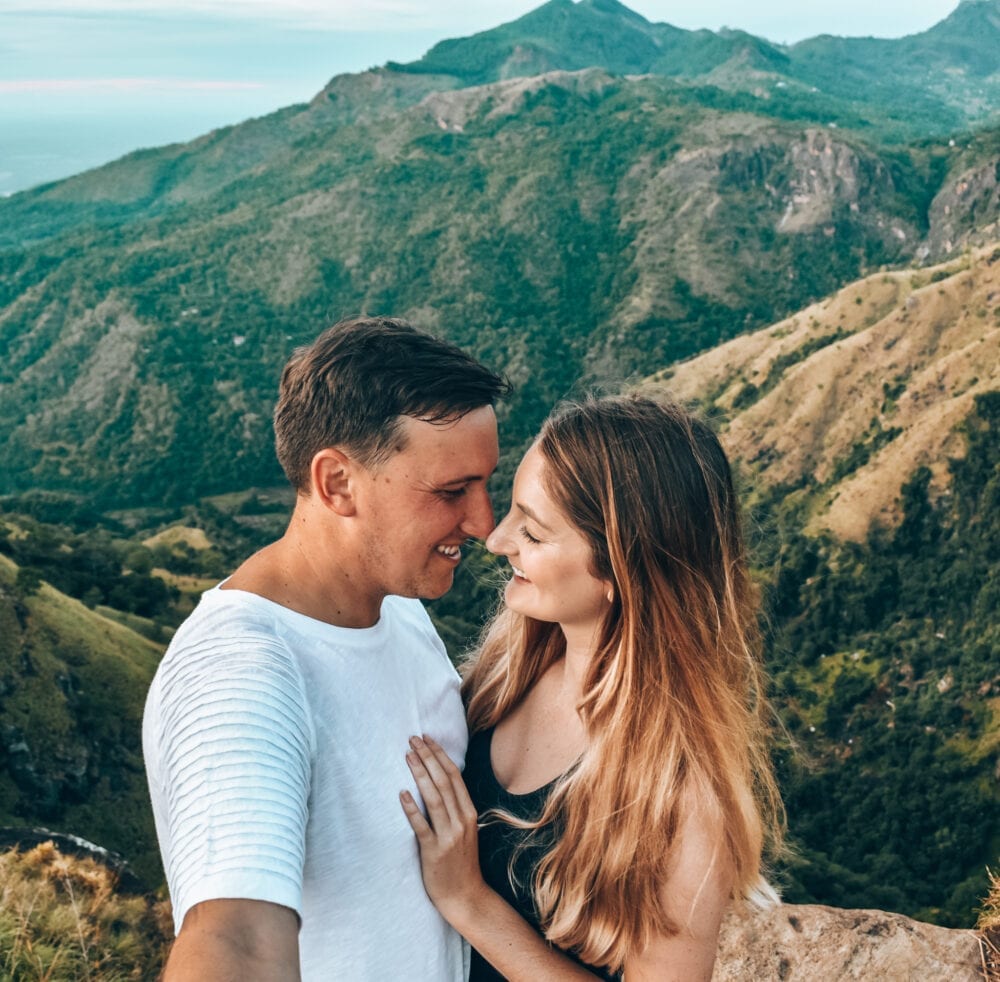 Couple standing at little Adams Peak viewpoint.