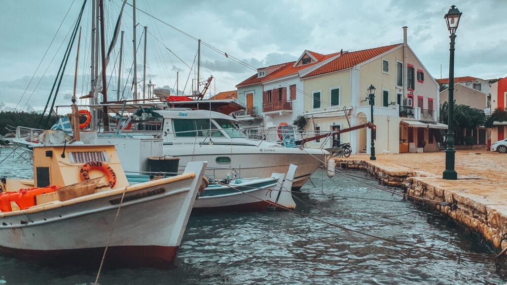 Fiskardo Bay in Kephalonia, boats and buildings in Fiskardo Harbour.