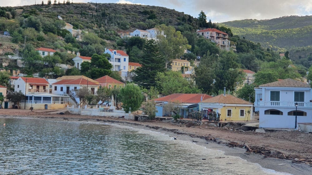 Scenic bay with stunning sea water, pine trees. Assos village