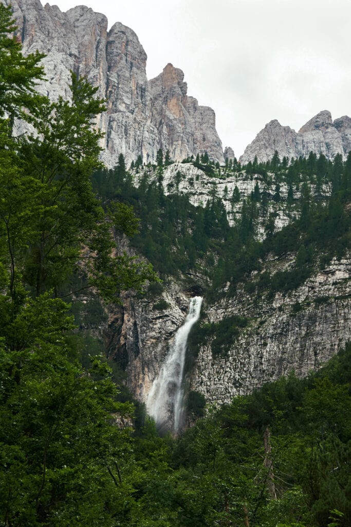 Sorapis Hike, waterfall and mountain range. The Dolomites. Best Hikes in Italy